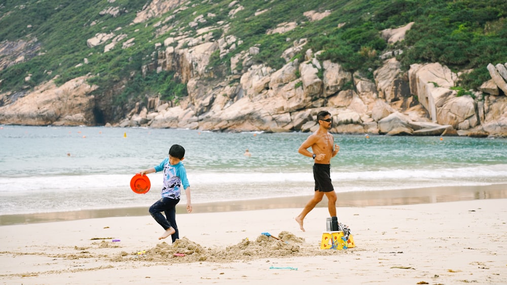 a couple of people that are standing in the sand