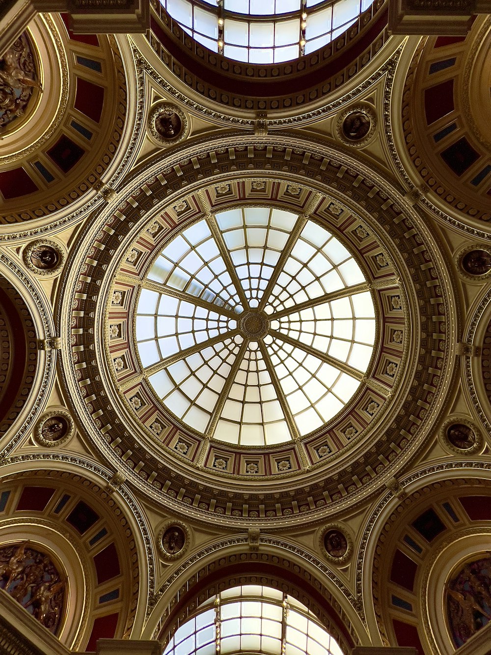 the ceiling of a building with a circular glass window