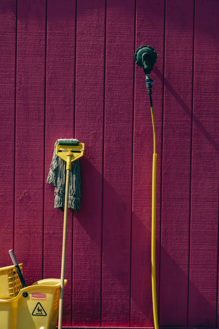 Mop and bucket against a wall, ready for floor cleaning