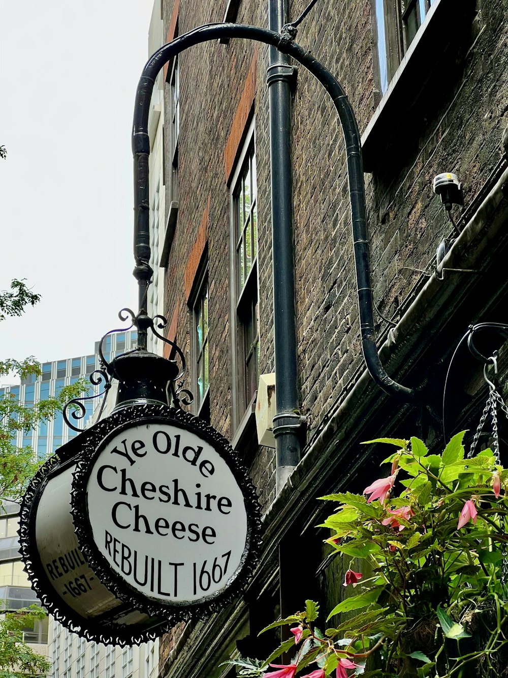 a black and white sign hanging from the side of a building