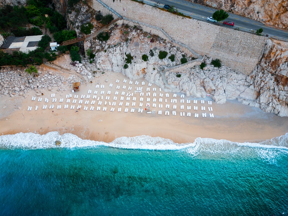 an aerial view of a beach with a lot of chairs