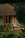 Cozy stone cottage surrounded by lush greenery in Sandinha village