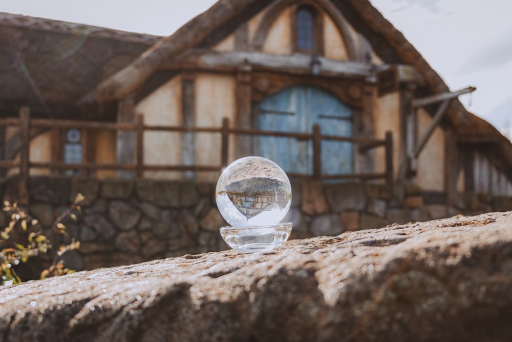 a glass ball sitting on top of a rock