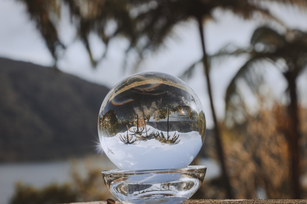 a glass ball sitting on top of a wooden table