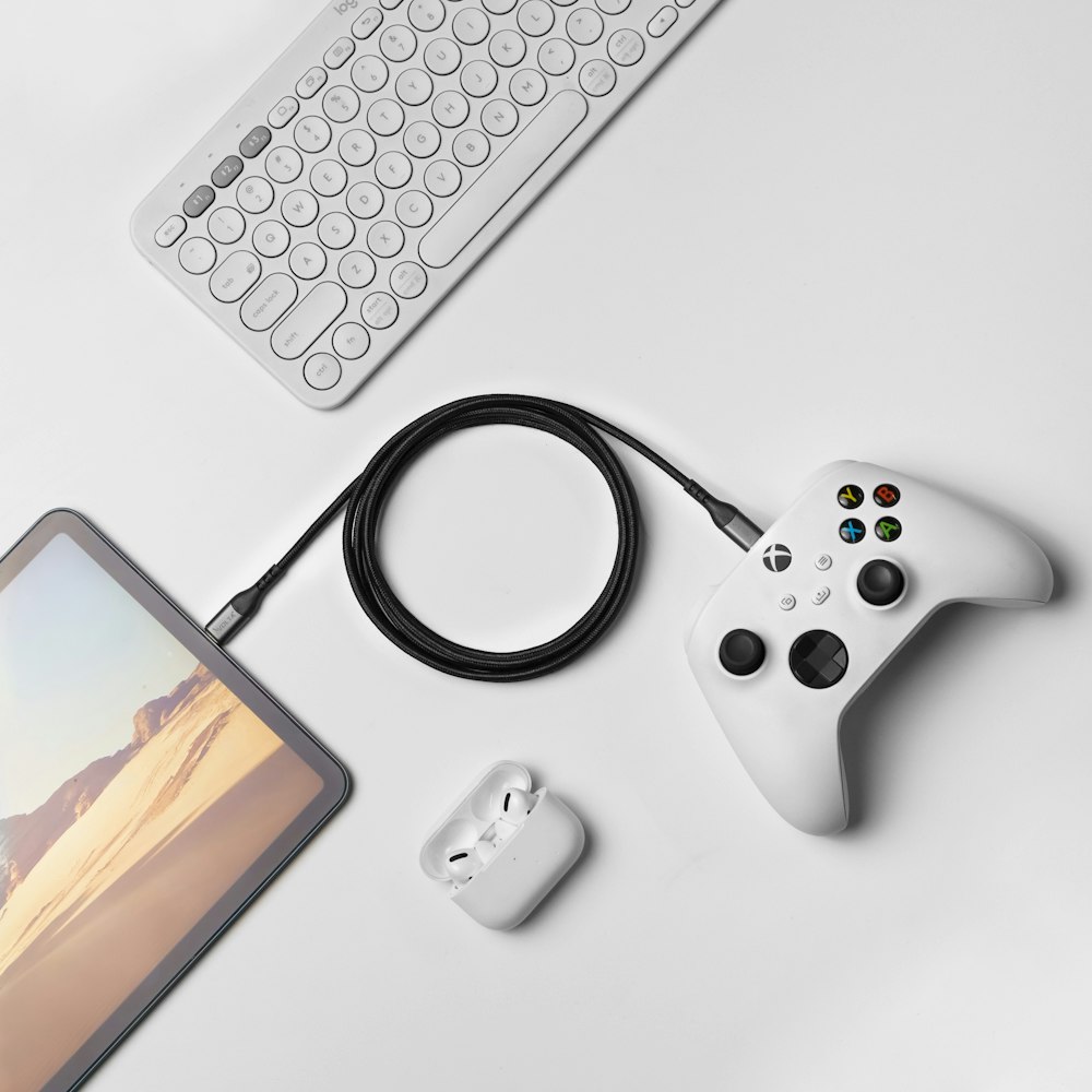 a white controller and a tablet on a table