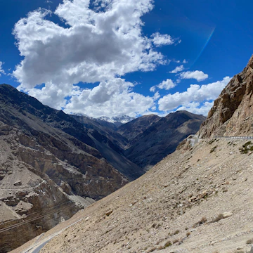 A winding mountain road leading to Skardu with rugged peaks surrounding.