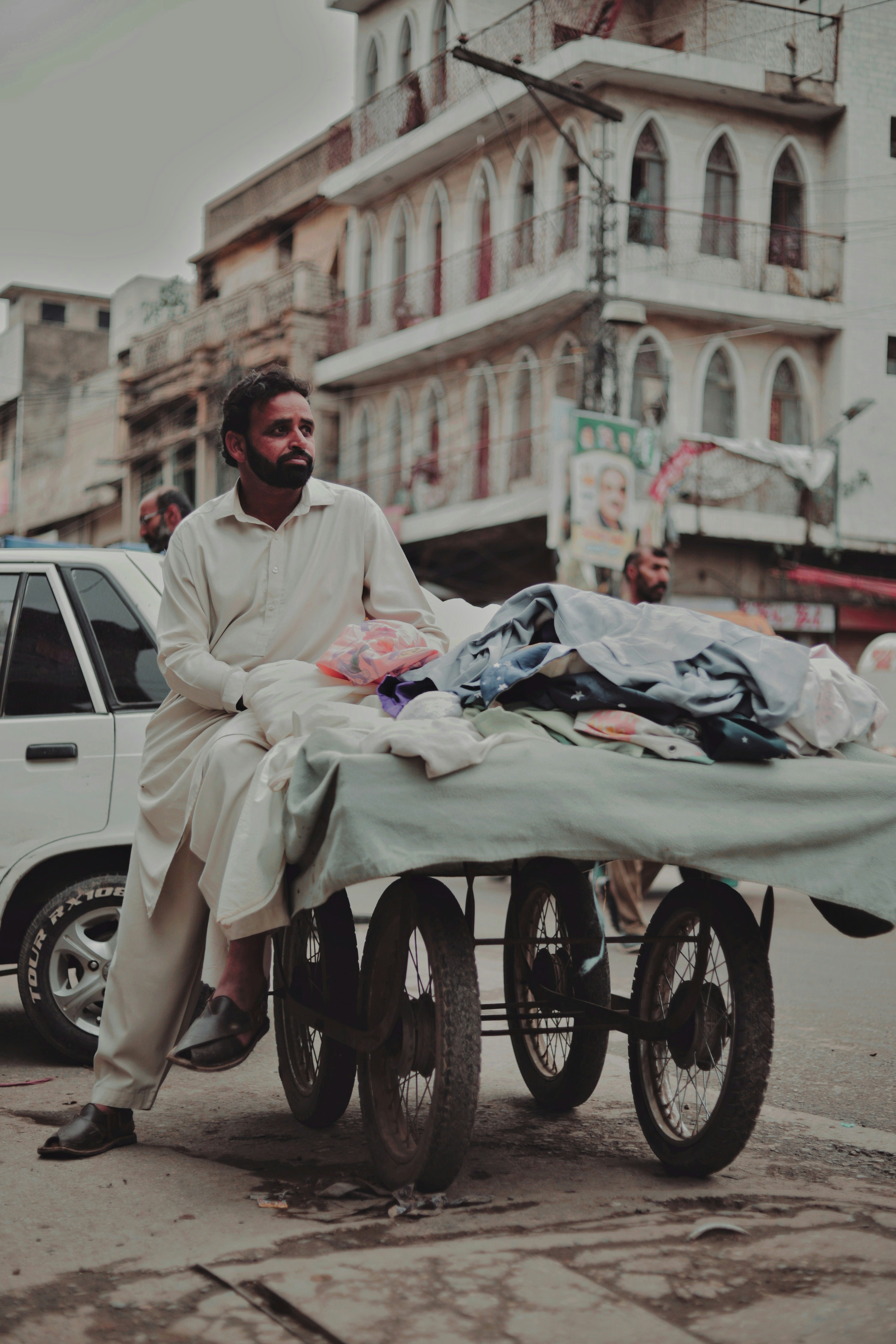 a man sitting on top of a bed on a cart