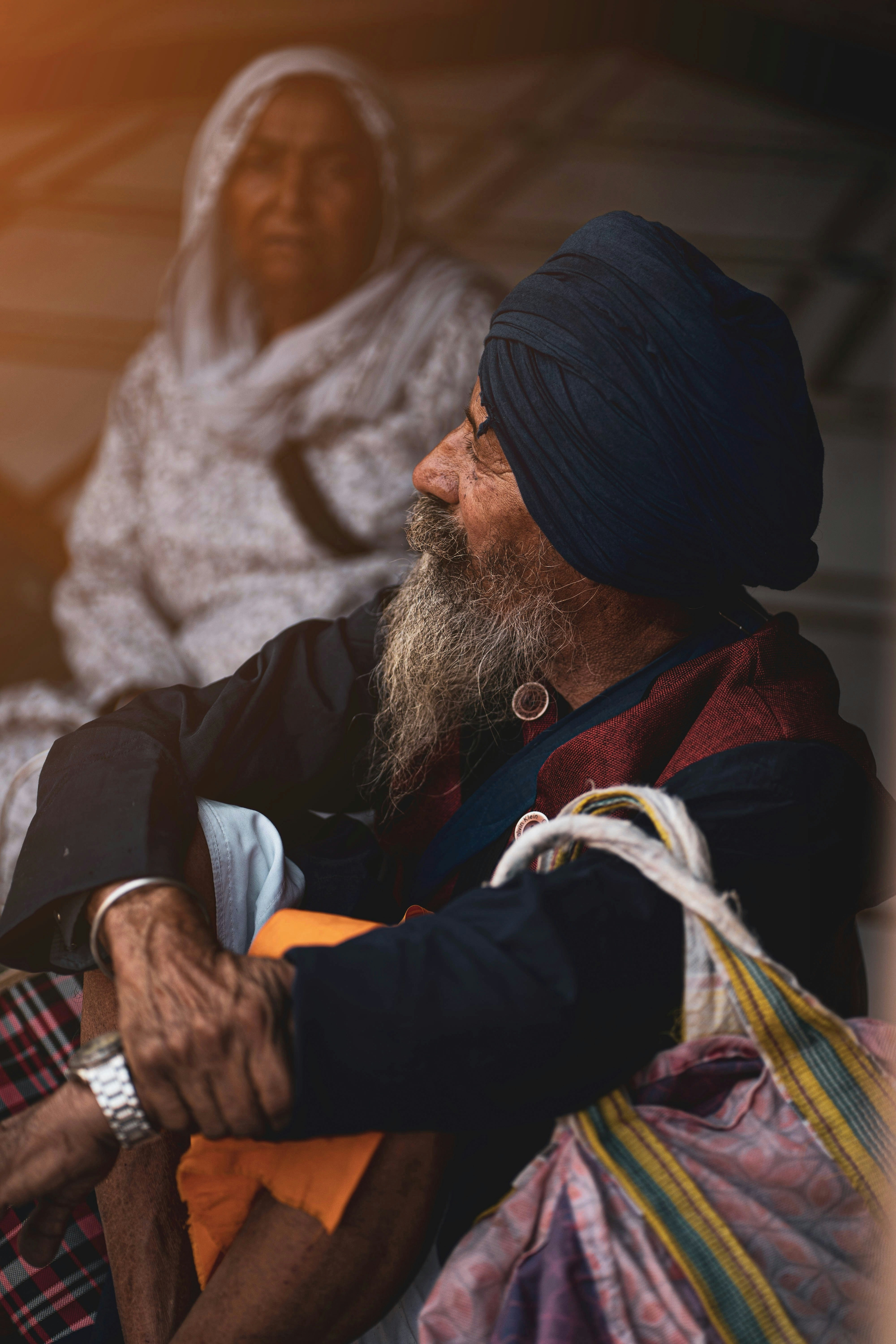 a man with a turban sitting next to a woman