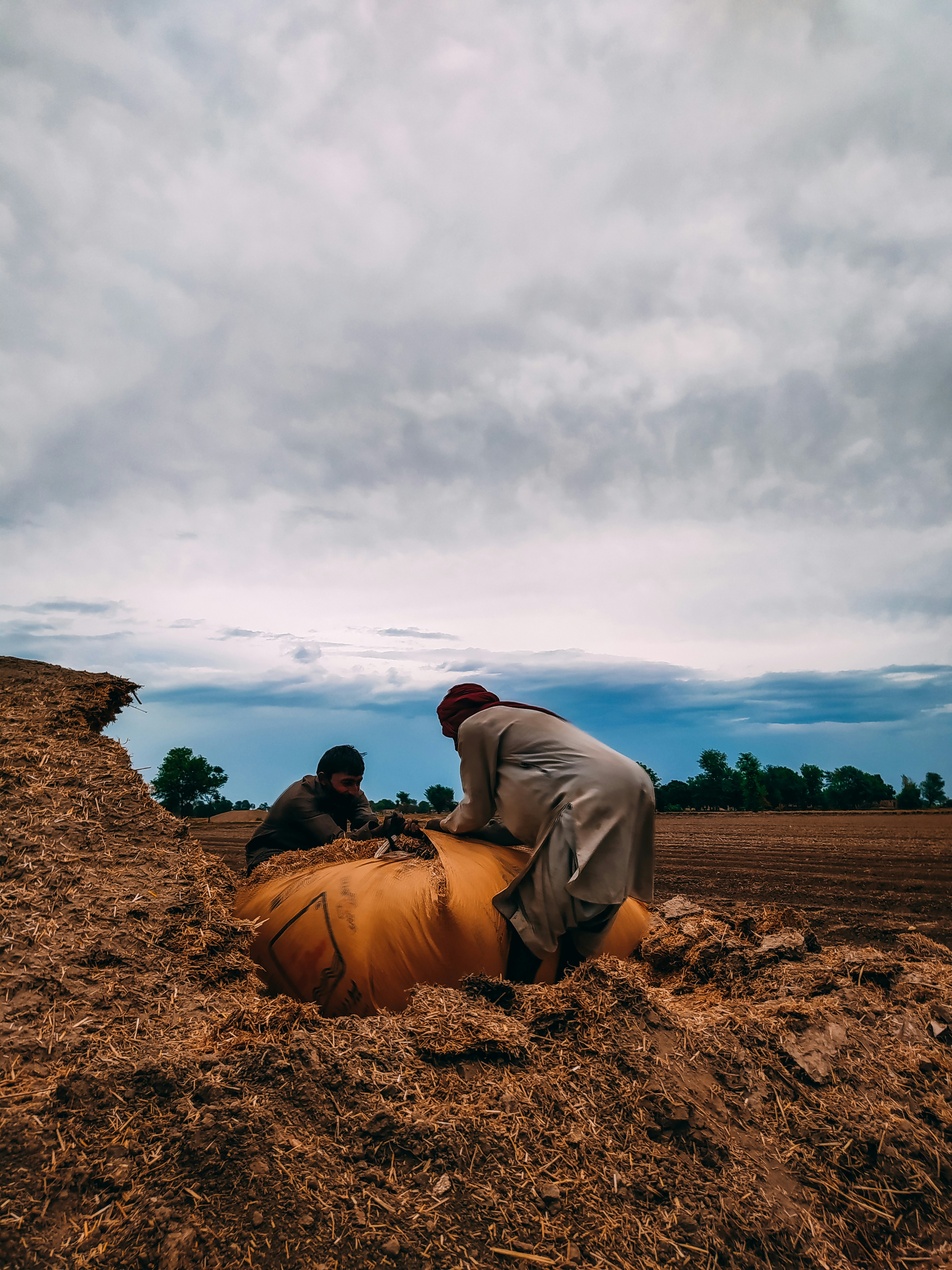 a couple of men standing next to each other on a field