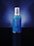 A blue bottle with a silver cap is centered against a dark blue gradient background. The bottle features white text displaying its brand and product name.
