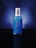 A blue bottle with a silver cap is centered against a dark blue gradient background. The bottle features white text displaying its brand and product name.