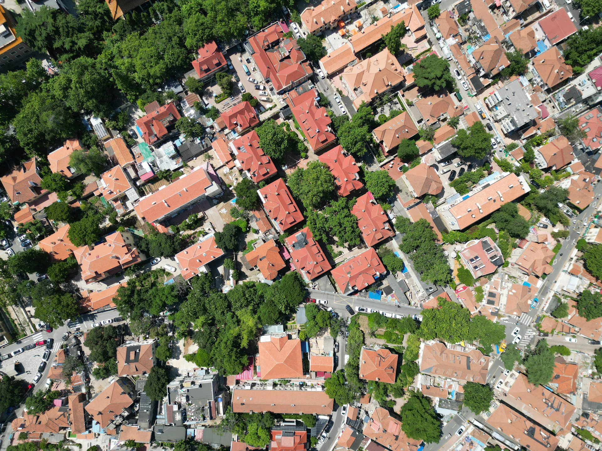 an aerial view of a city with red roofs