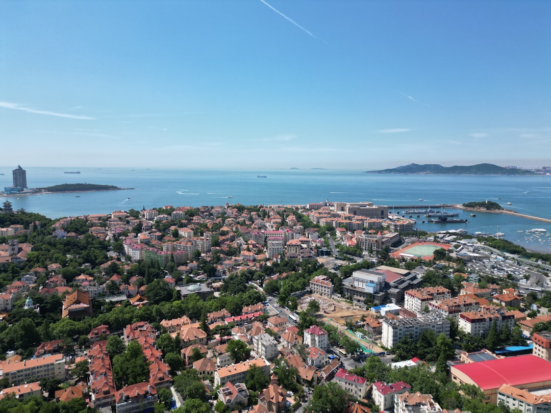 an aerial view of a city next to a body of water,