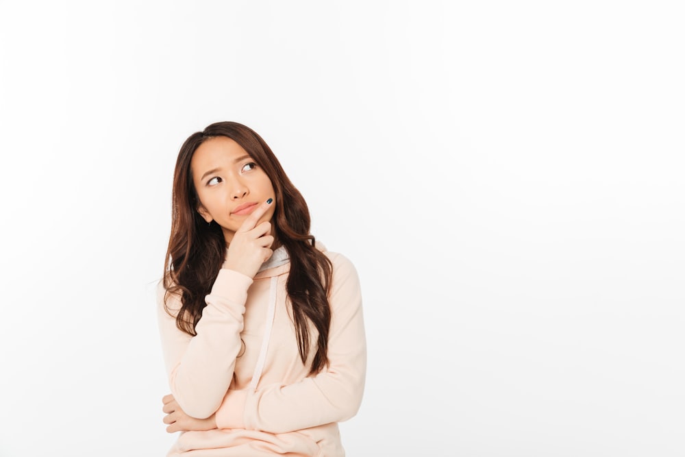 a woman in a pink sweater is looking up