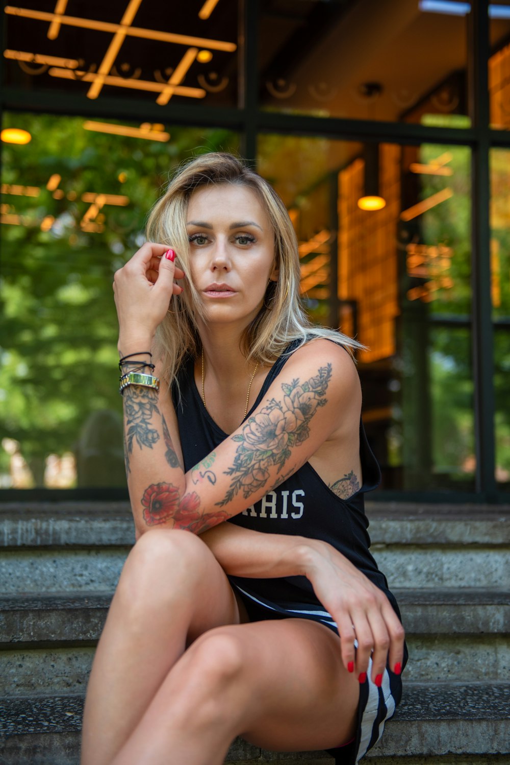 a woman with tattoos sitting on the steps