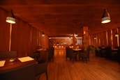 A cozy restaurant interior with warm lighting and inviting wooden tables at mangalking.