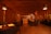 A cozy restaurant interior with wooden tables and warm lighting.