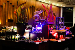 Elegant spread of regional specialties and festival foods styled with charcoal and gold decorative elements.