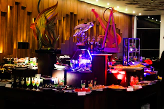 Elegant buffet setup under string lights, featuring island-inspired appetizers and vibrant decor.