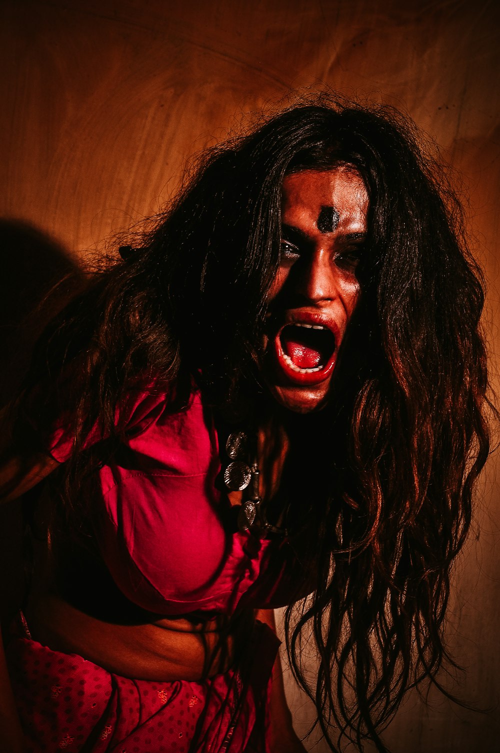a woman with makeup and blood on her face