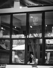 A candid photo showing the agent discussing property options with clients in a cozy cafe setting.