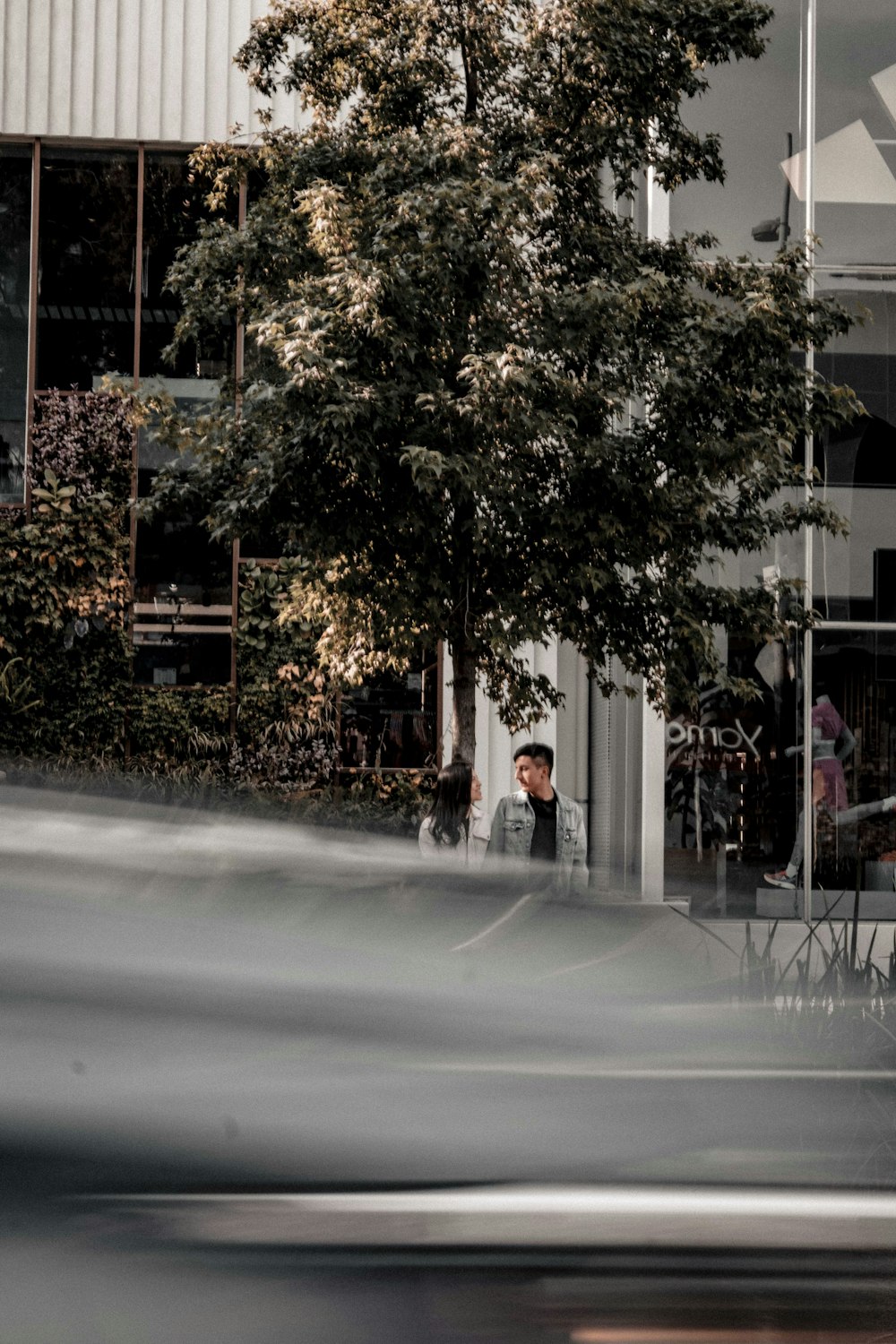 a blurry photo of a man sitting at a table in front of a building