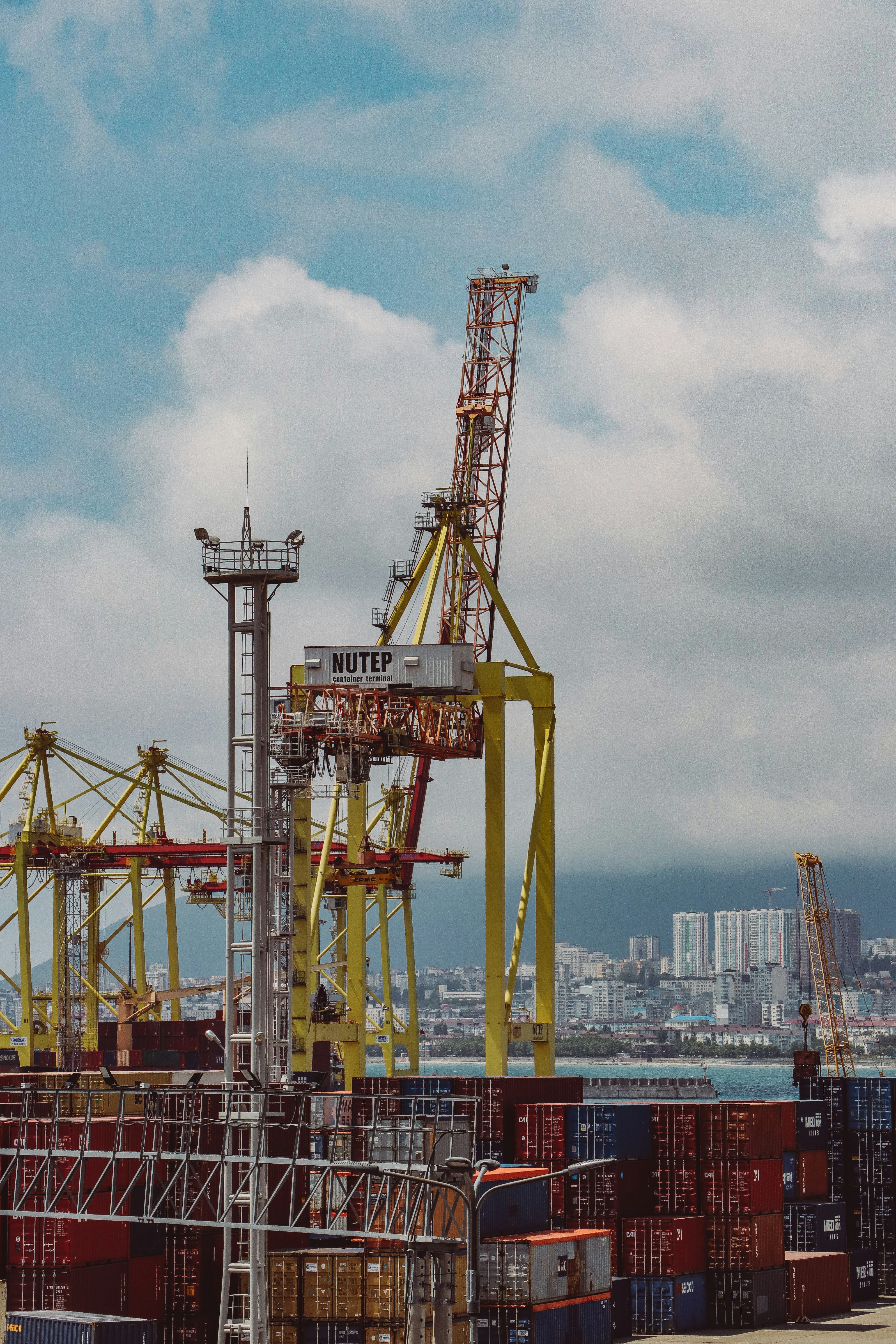 A bustling international port with cargo containers stacked high.