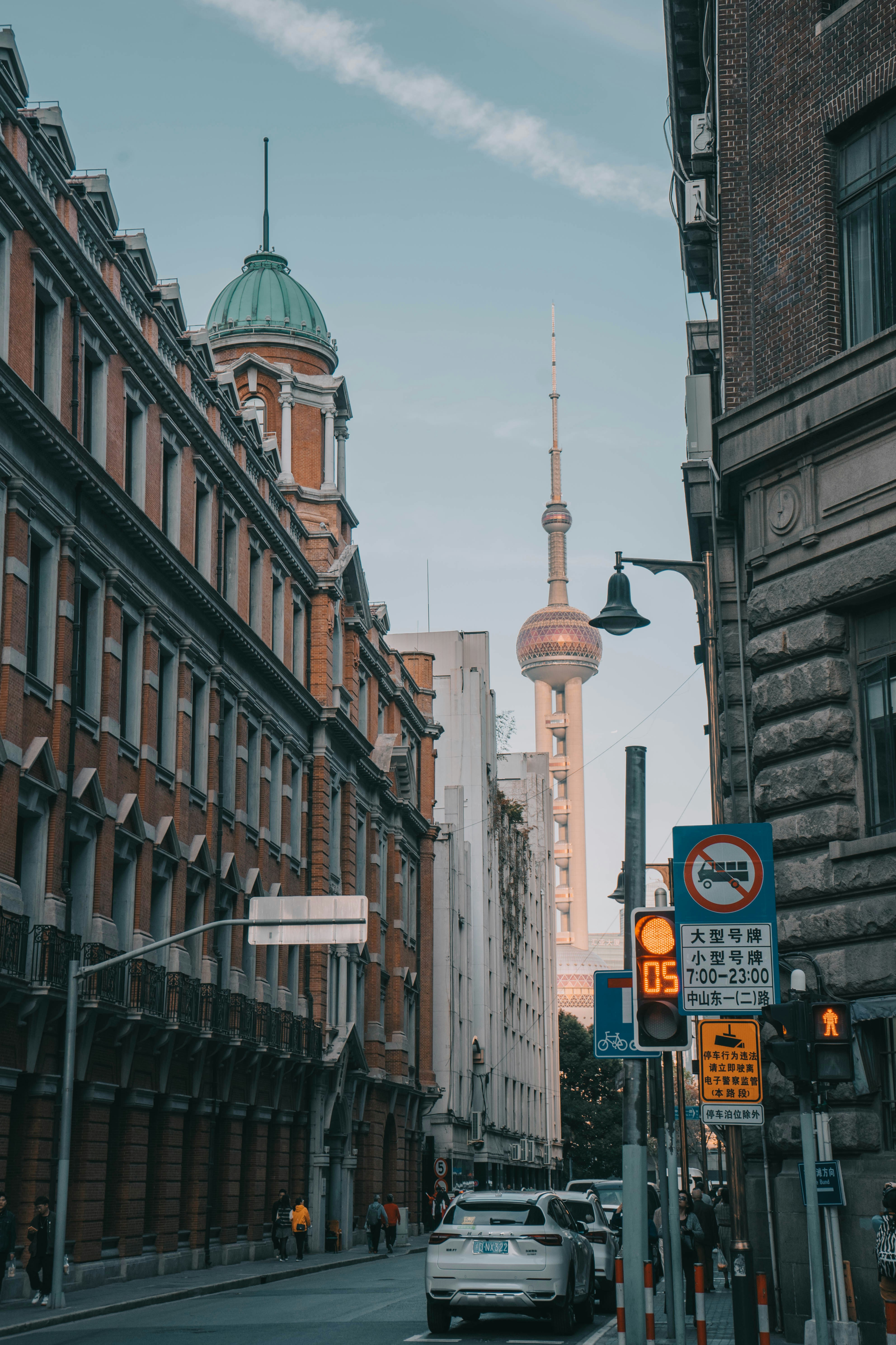 A city street lined with tall buildings and a traffic light photo ...