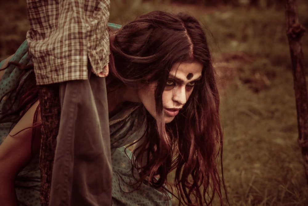 a woman with long hair and a creepy look on her face