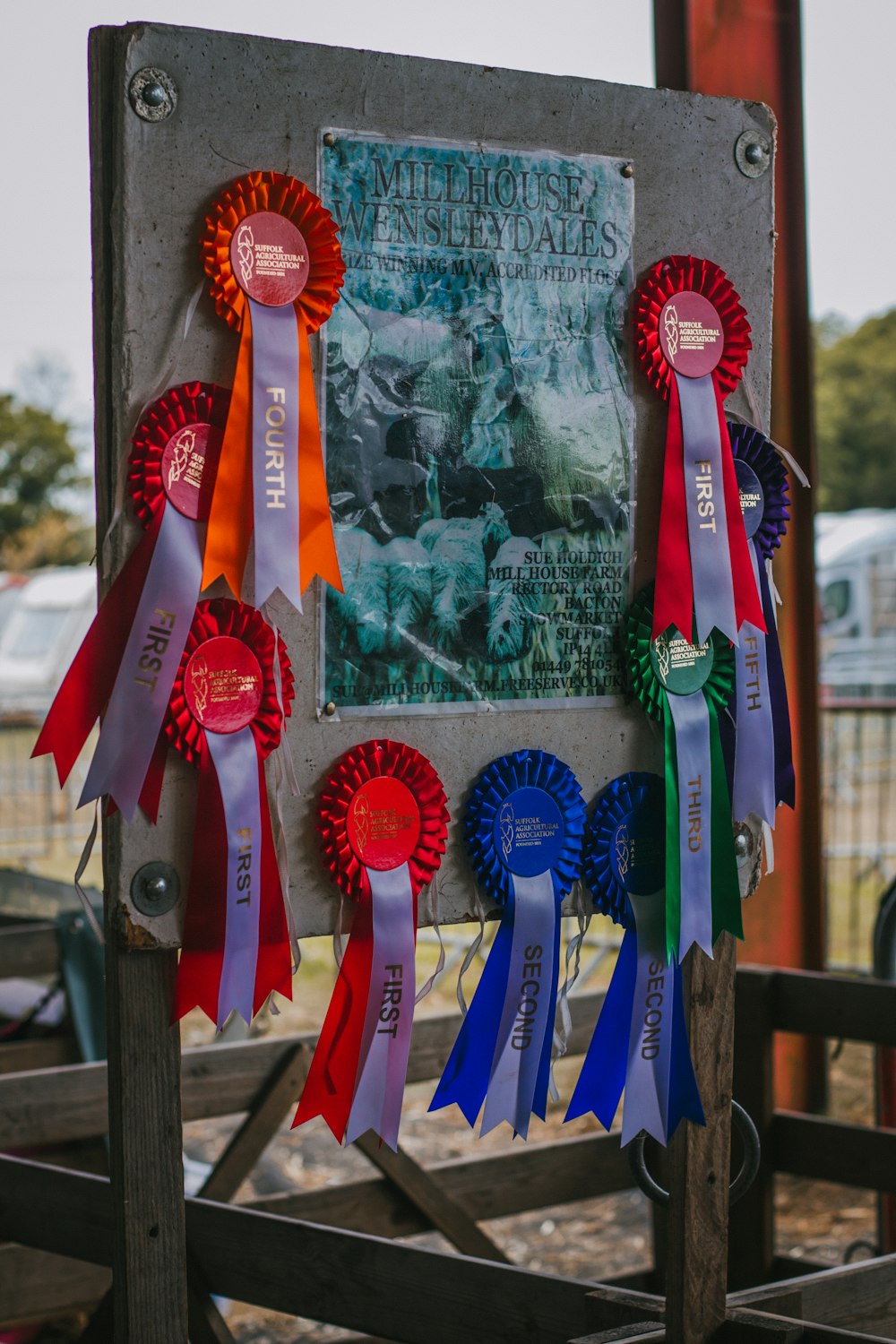 a sign with several ribbons attached to it