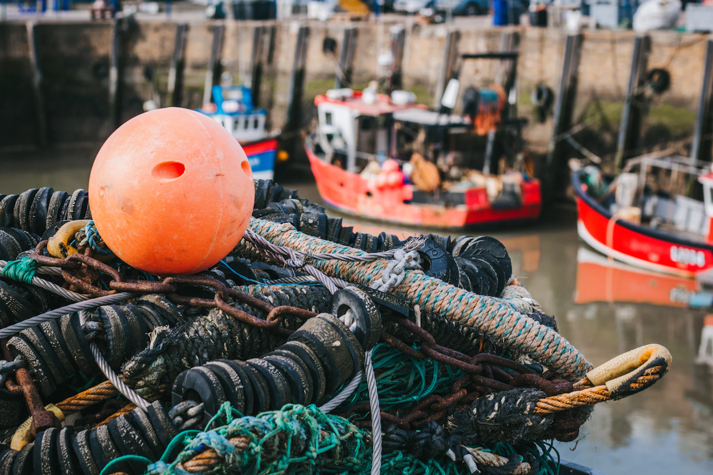 Stacked commercial fishing nets beside the water, representing the vessel and gear conditions at the center of maritime legal claims