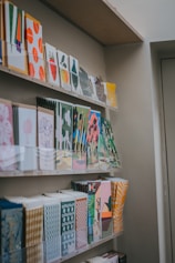 a bunch of cards on a shelf in a room