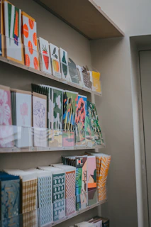 a bunch of cards on a shelf in a room