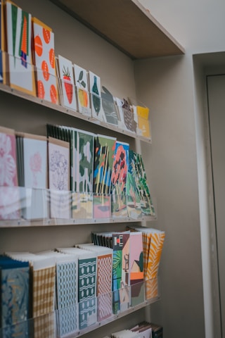a bunch of cards on a shelf in a room