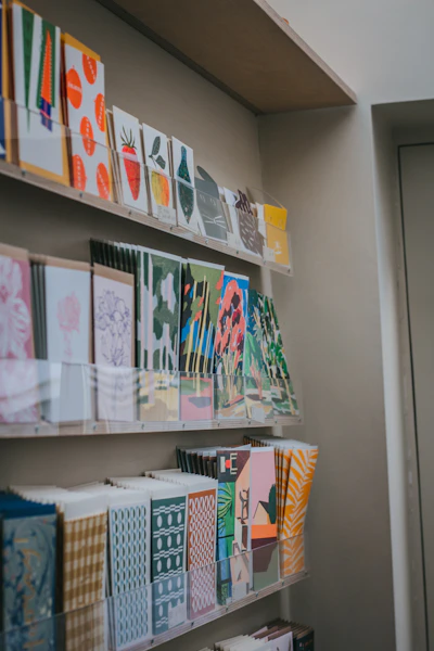 a bunch of cards on a shelf in a room