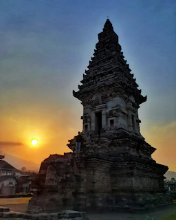 An ancient temple silhouette at sunset, symbolizing the deep roots and enduring philosophy of Kantoso.