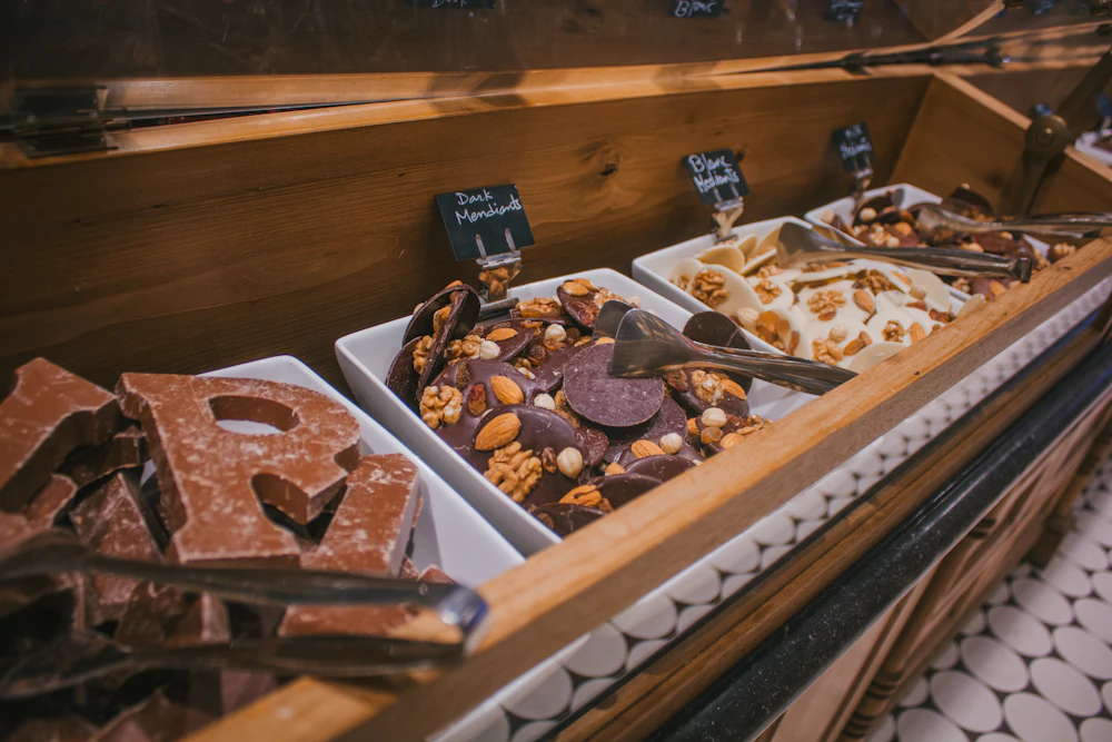 A display case filled with an assortment of sweets and desserts