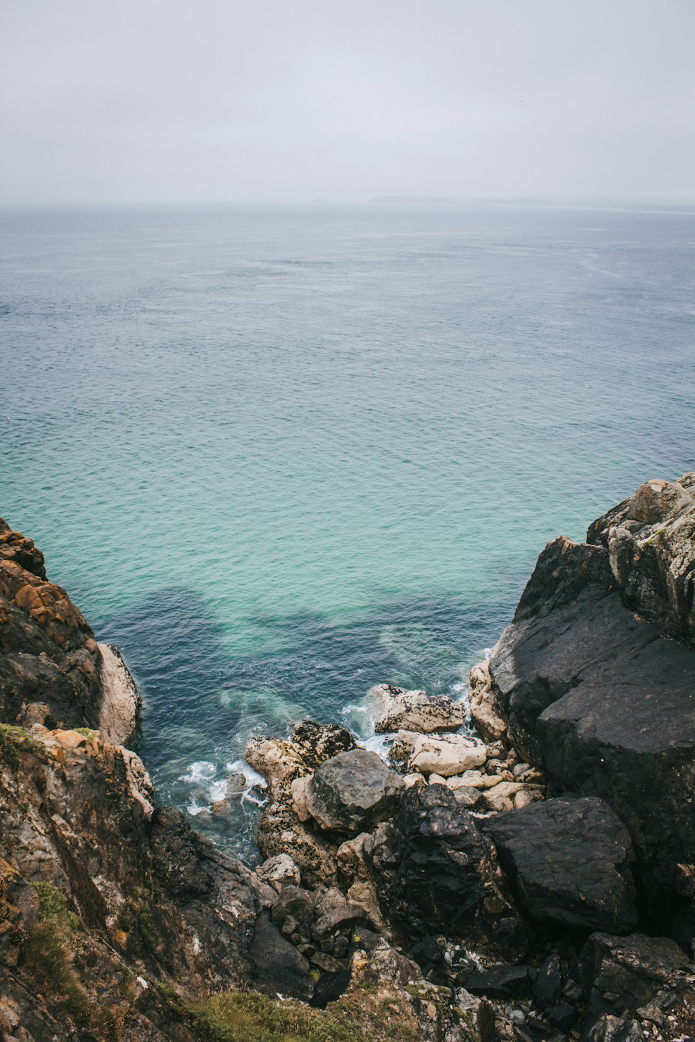 a view of the ocean from a rocky cliff