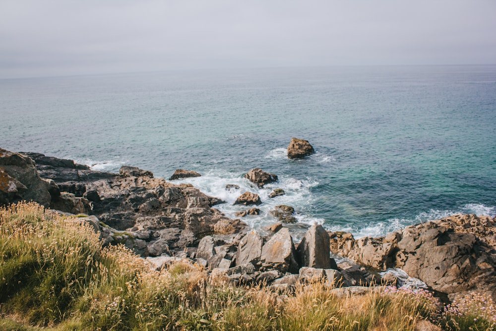 a view of the ocean from a rocky cliff