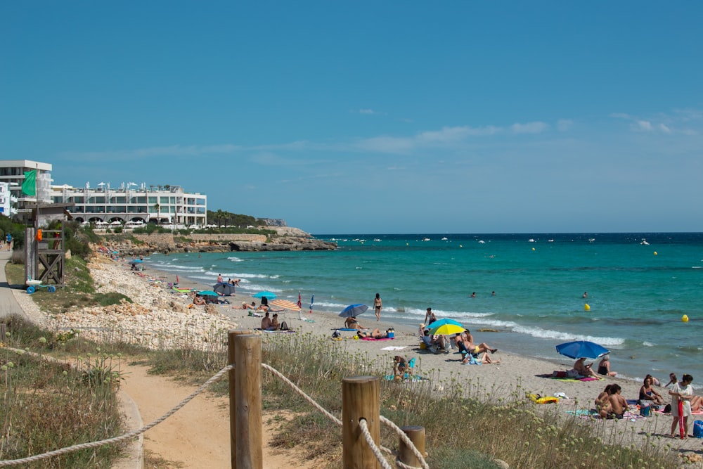 a crowded beach with people on the sand and in the water