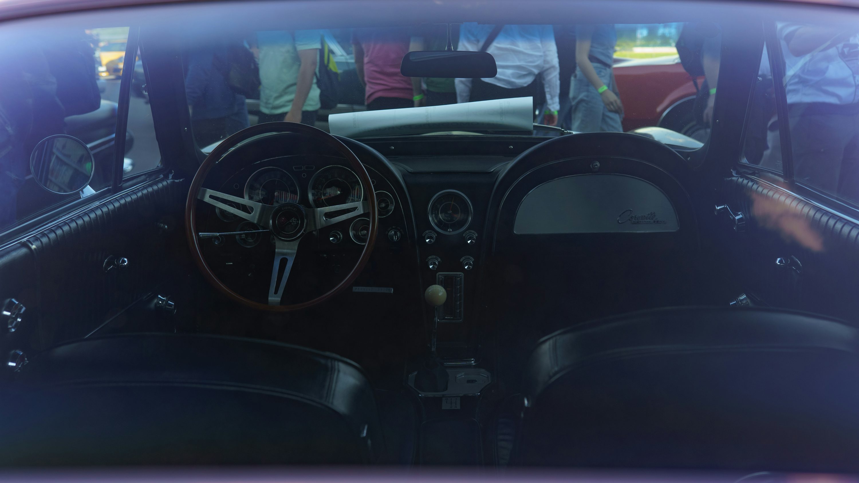 the interior of a car with a clock on the dashboard