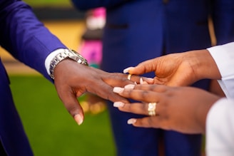 a close up of a person holding another person's hand