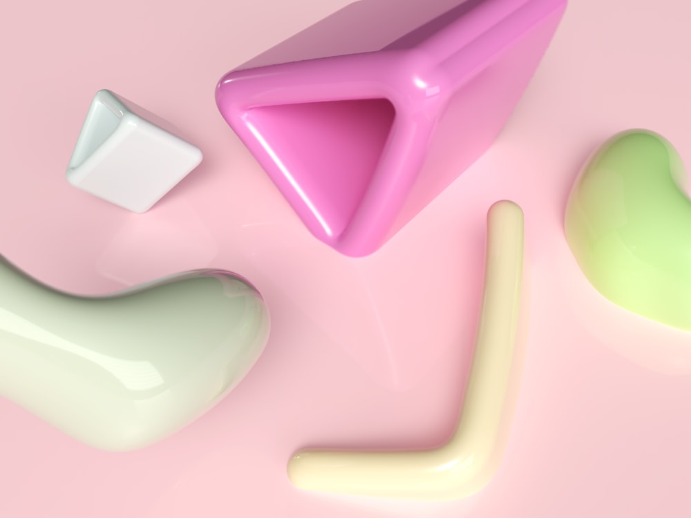 a group of different shapes on a pink surface