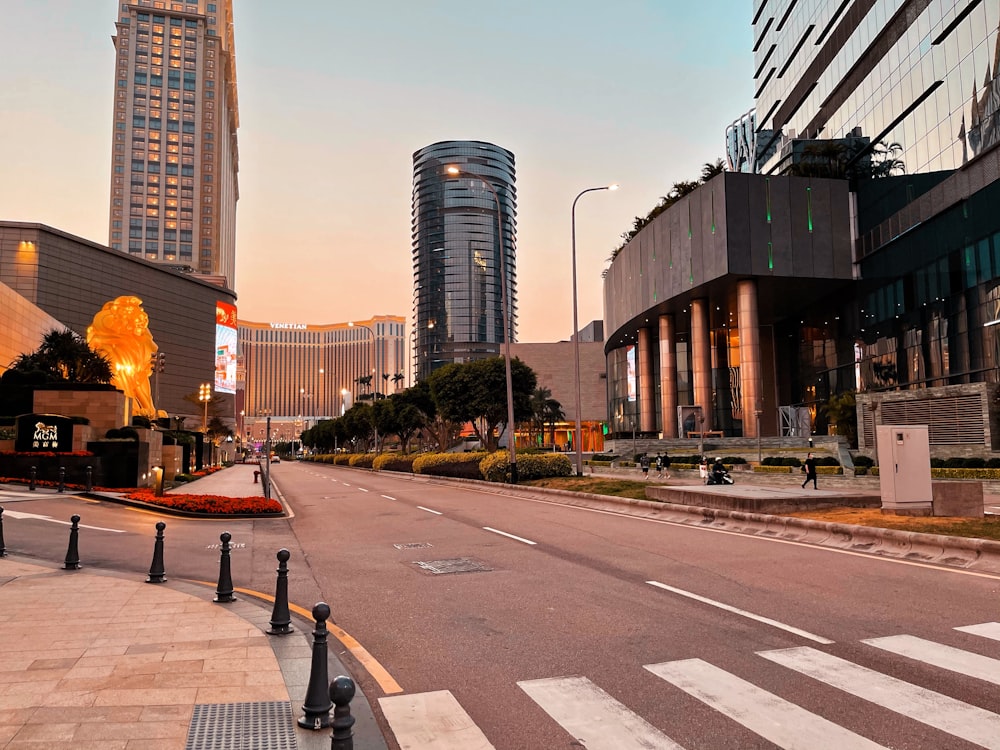 a city street with tall buildings in the background