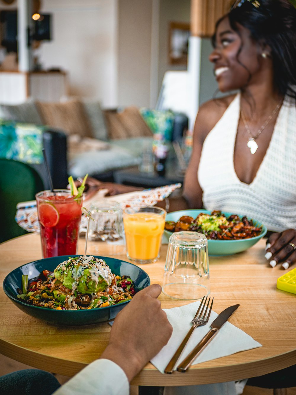 a woman sitting at a table with a plate of food