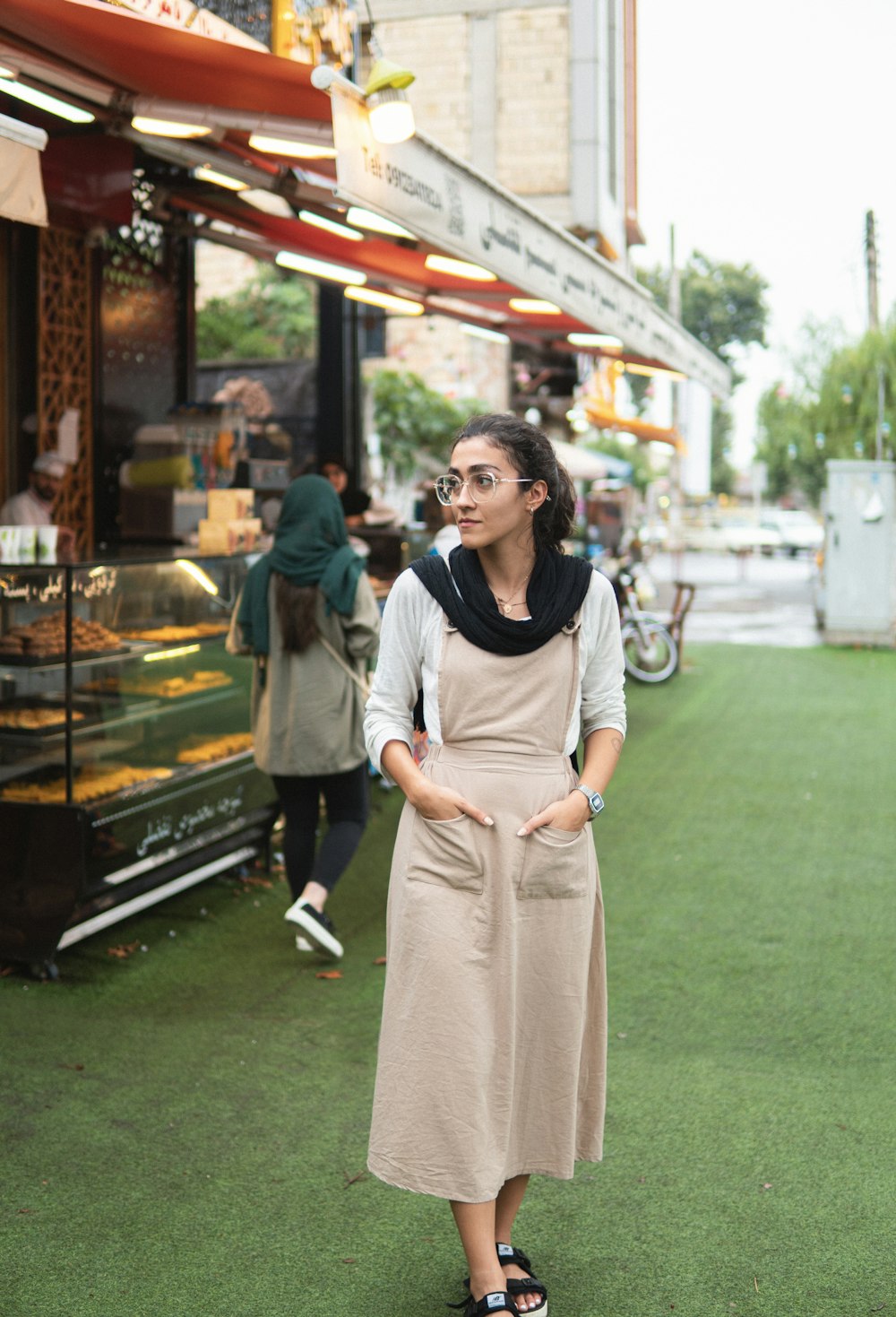 a woman standing in front of a store