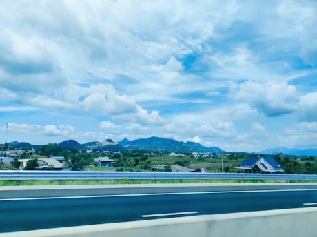 A scenic view of the countryside along Route 1 in San José, Uruguay, with rolling hills and a clear blue sky.