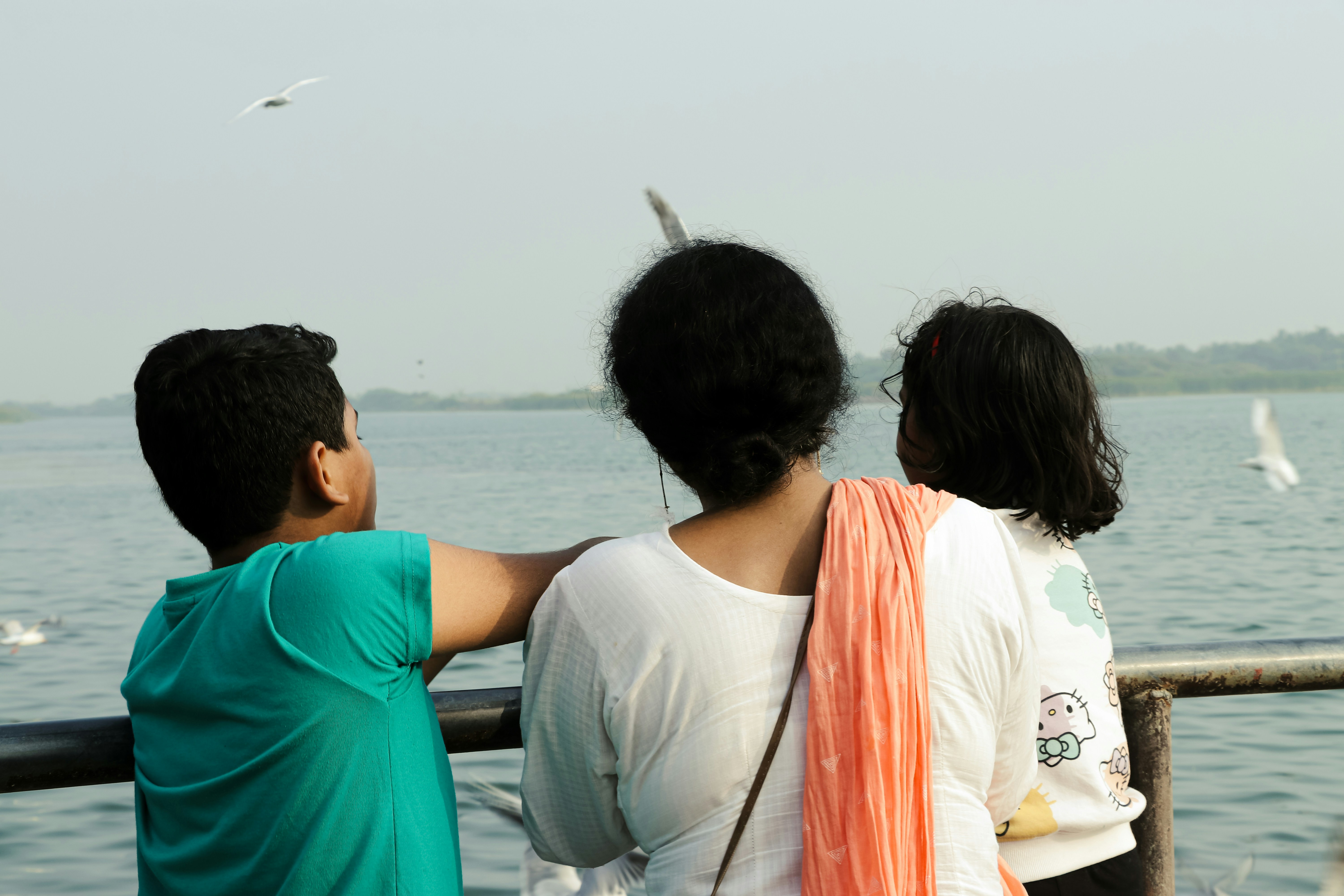 a couple of people that are looking at the water