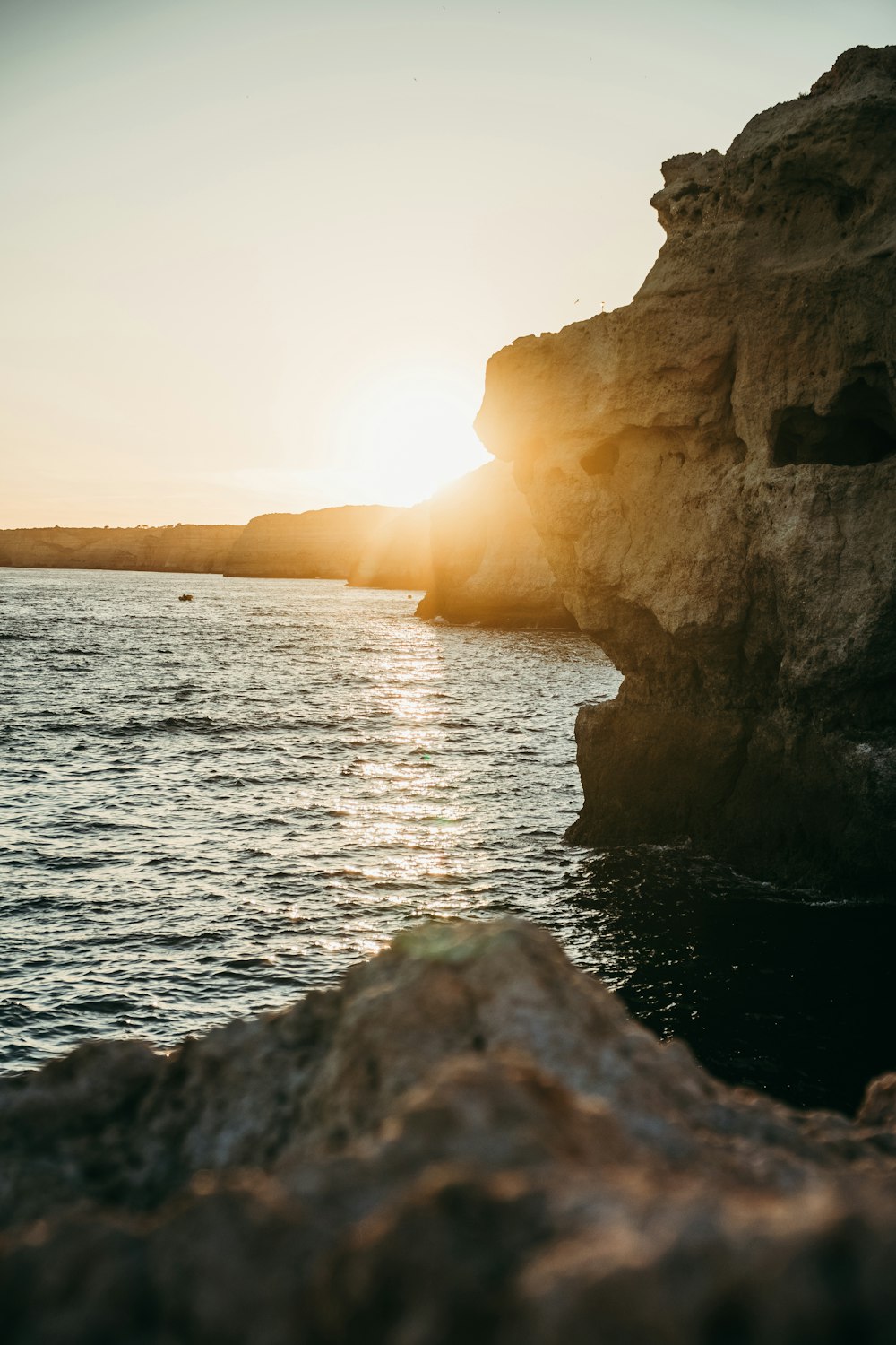 the sun is setting over a body of water