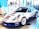 A sleek, white sports car decorated with various sponsor logos on its body. It's displayed in an indoor setting with a modern almost minimalist interior, including blue and white walls, large windows, and promotional banners in the background.